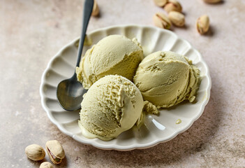 pistachio ice cream scoops on beige plate