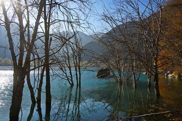 Obraz premium Lake Issyk in the rays of the setting sun. National Nature Park. Mountainous area with different vegetation.