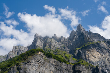 This landscape photo was taken in Europe, France, Auvergne-Rhone-Alpes, Haute-Savoie, Sixt-Fer-a-Cheval, in summer. It shows the cliffs in the Cirque du Fer-a-Cheval, under the Sun.