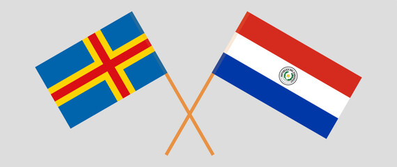 Crossed flags of Aland Islands and Republic of Paraguay. Official colors. Correct proportion. Vector illustration