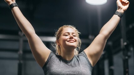 Strength and Triumph: A triumphant individual celebrates personal fitness achievements with arms raised high, embodying physical and mental strength.