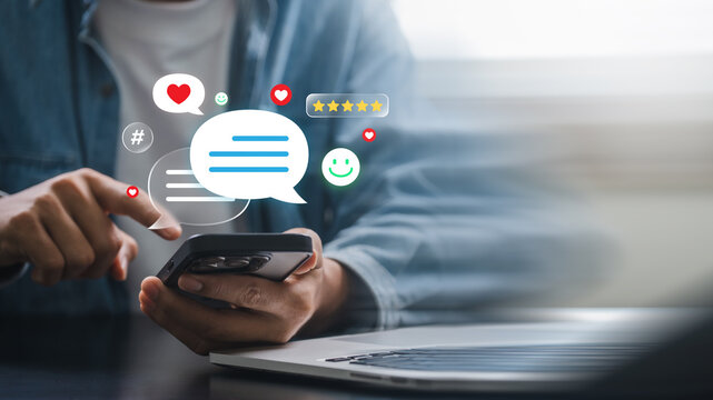 Digital messaging and user review concept showing person typing on mobile device with smile icons, comment bubbles and rating stars in online platform and social engagement for customer satisfaction