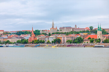 View of Budapest, Hungary, shows the Buda side from across the Danube River. The iconic Buda Castle and Fisherman Bastion are visible on Castle Hill
