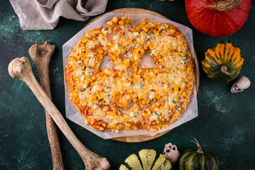 Halloween scary pizza in shape of pumpkin