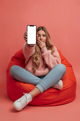 Woman in yellow jacket holding smartphone isolated on transparent background