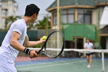 Focused tennis players competing on an outdoor court, showing teamwork, energy, and sportsmanship