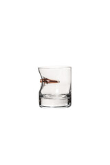 A lowball whiskey glass with a copper bullet embedded in the side, isolated on a white back