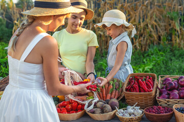 Family at a farmers market with vegetables. Selective focus.