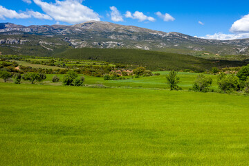 Obraz premium This landscape photo was taken in Europe, Spain, Aragon, Huesca, Samitier, in summer. It shows the fields and mountains around Bierge, under the Sun.