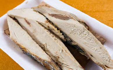 Close up Piece of small tuna in styrofoam with yellow background, raw food, fish market.