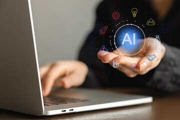 A person is holding a laptop with a blue circle on it that says AI