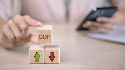 GDP economic growth and decline concept with wooden blocks and arrow icons showing global financial performance
