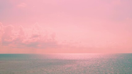 Amazing sunset sea in sunlight soft light pink orange peach sky colored plump clouds and sun. Colorful dawn sky sun clouds beach horizon, turquoise ocean bay vacation seascape travel relax paradise. - Powered by Adobe