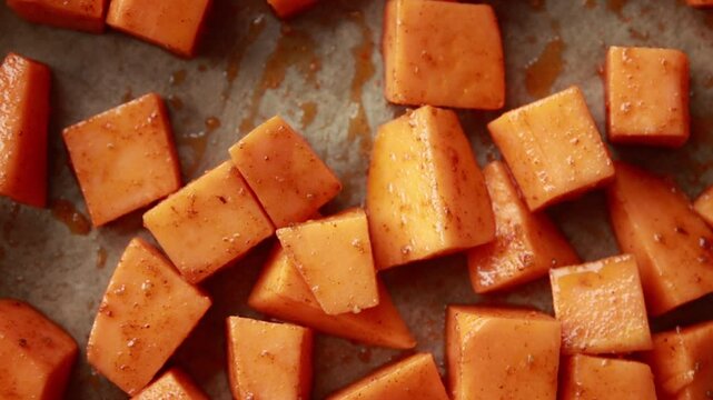 raw sweet potato cubes in tray ready to bake close up