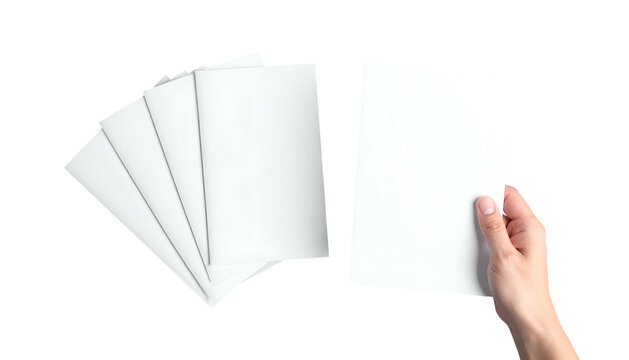 Hand holding blank paper next to a stack of papers, isolated on black background