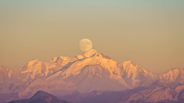 Full moon rising behind Mont Blanc mountains