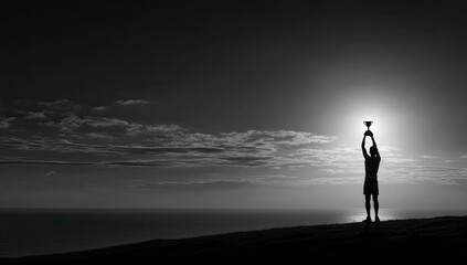 Silhouette of a person holding up a trophy with the ocean and sun in the background