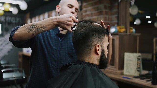 Hairdresser cutting a male client's dark hair with scissors and comb in a modern barbershop, close-up on hands and head highlighting precision, style and professional grooming
