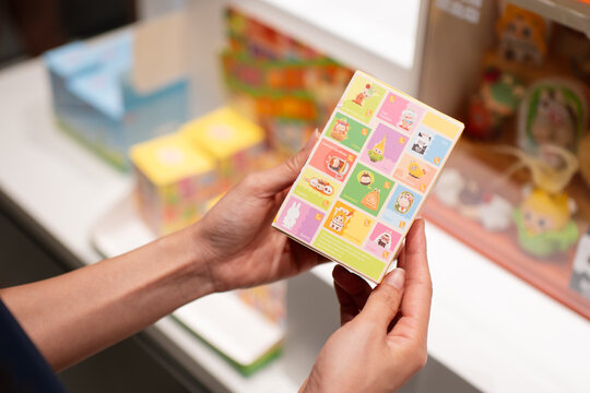 KUALA LUMPUR, MALAYSIA - AUG 16, 2025: Close up of a person holding a Pop Mart "The Monsters" Wacky Mart collectible blind box featuring Labubu character design in a retail store.