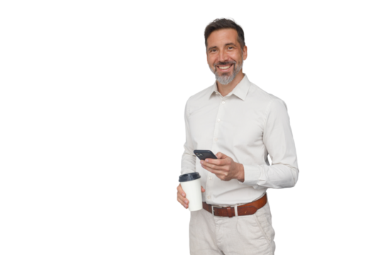 Smiling businessman holding coffee and phone, communicating and networking online, enjoying morning drink