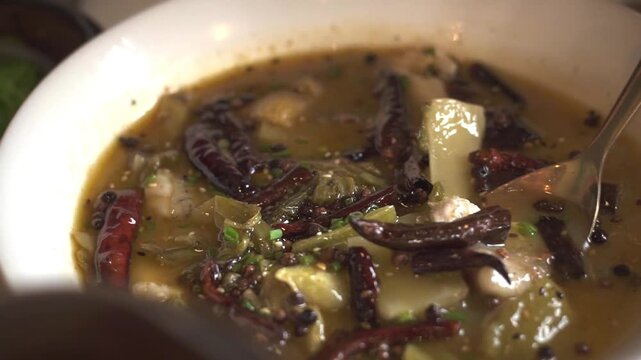 Sour fish soup local call Suan Chai Yu, A close-up shot of various dim sum dishes served in traditional bamboo steamers at Dim Sum restaurant. Cinematic lighting. Delicious dim sum, Chinese food.