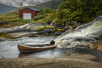 Fishing boat and fishing hut on a rainy day in Norway