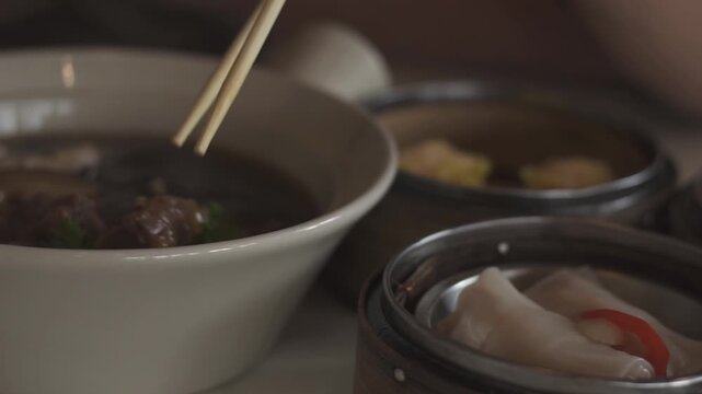 A close-up shot of various dim sum dishes served in traditional bamboo steamers at Dim Sum restaurant. Cinematic lighting. Delicious dim sum, Chinese food.