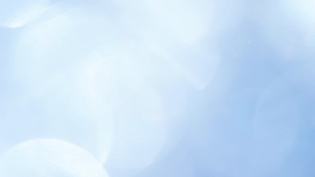 Swirling Bokeh in Blue Space. Loop. A large number of sparkling faceted crystals shimmer and create romantic bokeh