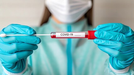 Nurse holds covid-19 swab test and sample tube