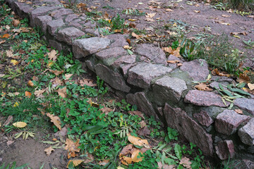 Colorful leaves and stone wall in a tranquil autumn garden