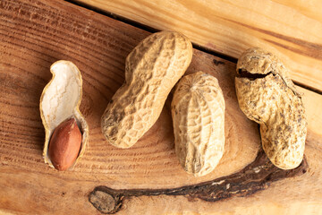 Unshelled raw peanuts, macro, top view.
