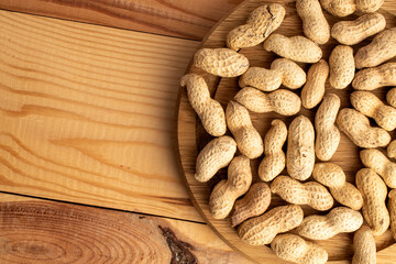 Unshelled raw peanuts, macro, top view.