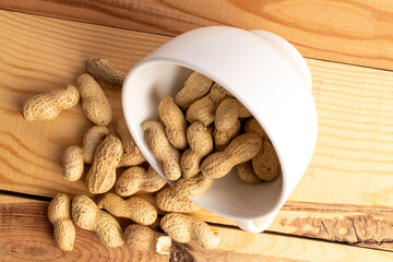 Unshelled raw peanuts, macro, top view.