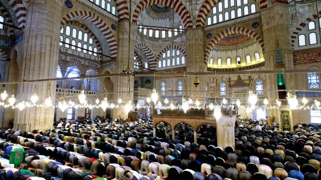 Muslim congregation performing prostration in a mosque. A spiritual moment symbolizing humility, devotion, and unity in Islamic worship.