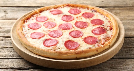 Delicious pepperoni pizza on wooden table, closeup