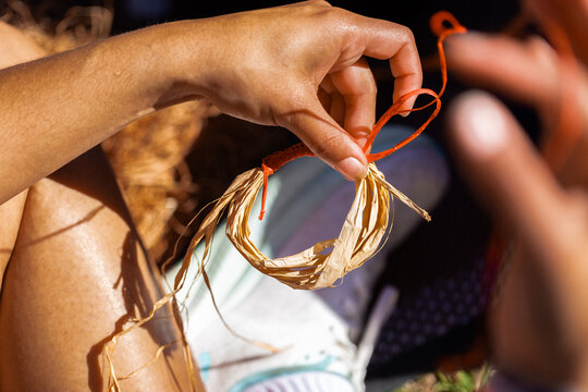 Young Aboriginal person weaving bracelet