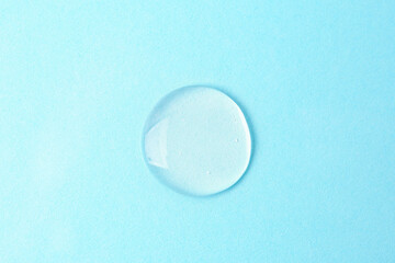Sample of cosmetic product on light blue background, top view