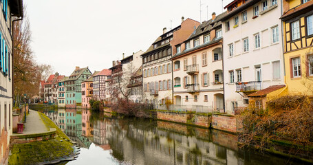 Traditional old alsatian houses from Pont st. Martin on a canal in Petit Venice (Small Venice) in Stasbourg. Est region in France with houses along the river.