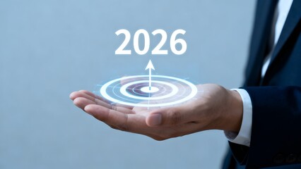 Hand holding futuristic hologram with year 2026