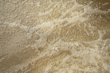 Hydrodynamic bubble formation in turbulent surface water layer