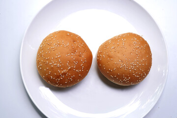 Brown hamburger buns isolated on white surface.