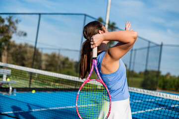 Female athlete focuses on a smash during a tennis game