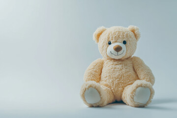 Obraz premium Adorable fluffy white teddy bear on a clean white backdrop, ideal for childhood, comfort, and innocence concepts