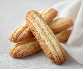 Close up view of lady finger biscuit cookie on white concrete background. Italian cookies savoiardi