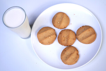 Sweet Snack Combination – Cookies and Milk Glass on White Background.