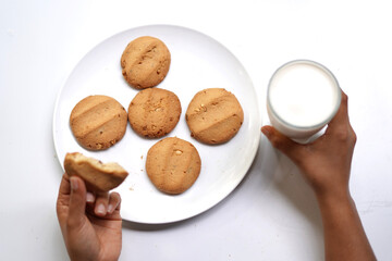 Eating Cookies with Milk Glass on White Background.