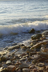 Waves crashing on a rocky shoreline at the edge of the ocean