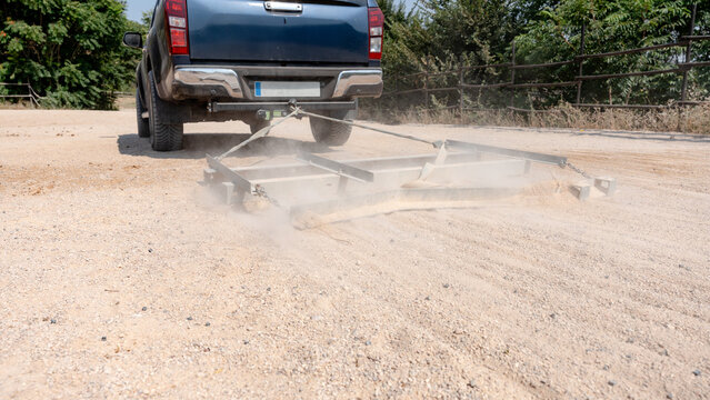Truck preparing equestrian arena surface for smooth riding