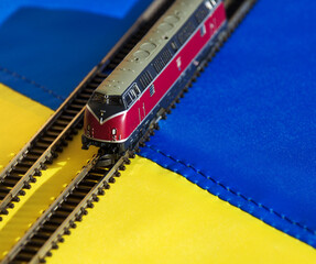 A model diesel locomotive against the backdrop of the Ukrainian flag.