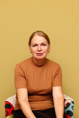 A serene, candid vertical portrait of a middle-aged 45 years blonde woman Caucasian. She is...